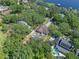 Eye-level aerial of the pool and the house nestled among a mature tree canopy near a lake at 11951 Elbert St, Clermont, FL 34711