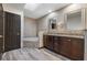 Bathroom with dark cabinets, grey tile, and a jacuzzi tub at 11951 Elbert St, Clermont, FL 34711