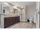 Bathroom with dark cabinets, grey tile, and a glass shower at 11951 Elbert St, Clermont, FL 34711