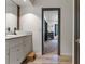 A bathroom with vanity sink and granite countertop is viewed from hallway entry at 11951 Elbert St, Clermont, FL 34711
