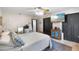 A modern bedroom featuring a dark closet, a television and a bed with decorative pillows at 11951 Elbert St, Clermont, FL 34711