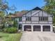 Charming multi-story home boasting a three-car garage, manicured lawn, and architectural details at 11951 Elbert St, Clermont, FL 34711