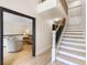 Open foyer with wood staircase, light wood flooring, and a view into the adjacent living area at 11951 Elbert St, Clermont, FL 34711