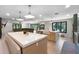 A spacious kitchen featuring two islands, hardwood floors and a view into the living room at 11951 Elbert St, Clermont, FL 34711