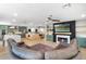 Spacious living room featuring a fireplace, modern furniture, and an open layout to the kitchen at 11951 Elbert St, Clermont, FL 34711