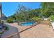 Backyard swimming pool enclosed by a safety fence, surrounded by a brick patio at 11951 Elbert St, Clermont, FL 34711