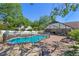Outdoor pool with black safety fence and brick patio under blue skies at 11951 Elbert St, Clermont, FL 34711