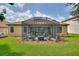 Screened back porch with outdoor furniture, fire pit, and garden views at 1353 Palmetto Dunes St, Davenport, FL 33836