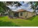 Spacious backyard with a screened-in lanai and lush green lawn at 1353 Palmetto Dunes St, Davenport, FL 33836