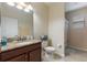 Bathroom with granite countertop vanity, tile floor, and shower at 1353 Palmetto Dunes St, Davenport, FL 33836
