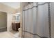 A well-lit bathroom with decorative shower curtain and vanity at 1353 Palmetto Dunes St, Davenport, FL 33836