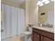 Bathroom with a shower/tub combination, granite countertop, dark wood vanity, and a large mirror at 1353 Palmetto Dunes St, Davenport, FL 33836