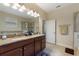 Bathroom features double sinks, granite countertops, a soaking tub, and a glass-enclosed shower at 1353 Palmetto Dunes St, Davenport, FL 33836