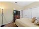 Bedroom with a neutral color scheme, TV, closet, and a window for natural light at 1353 Palmetto Dunes St, Davenport, FL 33836