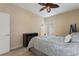 A cozy bedroom includes a ceiling fan and bright natural light at 1353 Palmetto Dunes St, Davenport, FL 33836