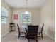 Cozy dining area with a glass table, neutral colors, and natural light at 1353 Palmetto Dunes St, Davenport, FL 33836