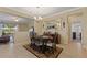 Elegant dining room with a chandelier, large mirror, and dark wood table and chairs atop an ornate rug at 1353 Palmetto Dunes St, Davenport, FL 33836