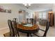 Elegant dining room showcasing a wooden table, stylish chairs, and views into living spaces at 1353 Palmetto Dunes St, Davenport, FL 33836