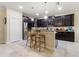 Gourmet kitchen with dark wood cabinets, granite countertops, and stainless steel appliances at 1353 Palmetto Dunes St, Davenport, FL 33836