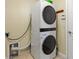 Laundry room including a stacked washer and dryer set at 1353 Palmetto Dunes St, Davenport, FL 33836