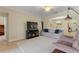 Comfortable living room with a fireplace, plush seating, and an open floor plan at 1353 Palmetto Dunes St, Davenport, FL 33836