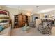 Comfortable living room with a decorative cabinet, plush seating, and neutral decor at 1353 Palmetto Dunes St, Davenport, FL 33836
