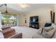 Cozy living room showcasing a sliding glass door, fireplace, and neutral tones at 1353 Palmetto Dunes St, Davenport, FL 33836