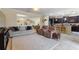 Inviting living room featuring plush seating, an open layout, and modern recessed lighting at 1353 Palmetto Dunes St, Davenport, FL 33836