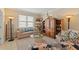 Relaxing living room featuring a decorative cabinet, plush seating, and ample lighting at 1353 Palmetto Dunes St, Davenport, FL 33836
