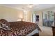 Well-lit main bedroom with a plush bed, ceiling fan, and access to a private outdoor area at 1353 Palmetto Dunes St, Davenport, FL 33836