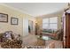 Charming sitting room featuring a cozy couch, glass table, and bright natural light at 1353 Palmetto Dunes St, Davenport, FL 33836