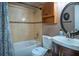 The bathroom features a bathtub with a shower, a toilet, and a vanity with a sink and mirror at 1375 Springfield St, Kissimmee, FL 34744