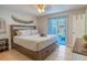 This bright bedroom offers a relaxing retreat with a comfortable bed and access to a private outdoor space at 1375 Springfield St, Kissimmee, FL 34744