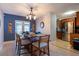 Bright dining area with a wood table set for four, decorated walls, and tile flooring at 1375 Springfield St, Kissimmee, FL 34744