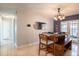 Bright dining area with wooden table set for four, and stylish decorations on the walls at 1375 Springfield St, Kissimmee, FL 34744