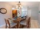 Bright dining area with wooden table set for four, and stylish decorations on the walls at 1375 Springfield St, Kissimmee, FL 34744