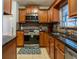 Well-lit kitchen features wood cabinets, stainless steel appliances, and granite countertops at 1375 Springfield St, Kissimmee, FL 34744