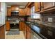 Well-lit kitchen features wood cabinets, stainless steel appliances, and granite countertops at 1375 Springfield St, Kissimmee, FL 34744