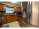 Kitchen featuring stainless steel refrigerator and appliances, along with wood cabinets at 1375 Springfield St, Kissimmee, FL 34744