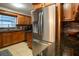 Kitchen showcases stainless steel refrigerator, wood cabinets, and granite countertops at 1375 Springfield St, Kissimmee, FL 34744