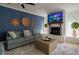 Cozy living room features a blue couch, stone fireplace, and a ceiling fan for comfort at 1375 Springfield St, Kissimmee, FL 34744