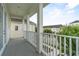 View of a balcony featuring white railings and columns, offering a view of a residential street and neighboring homes at 1379 Kiawah St, Celebration, FL 34747