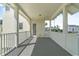 Covered balcony with white railings, offering outdoor living space with views of a building and palm trees at 1379 Kiawah St, Celebration, FL 34747