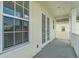 A glimpse of the covered balcony boasting a window and double glass doors, providing a relaxing outdoor area at 1379 Kiawah St, Celebration, FL 34747