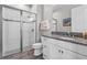 Bright bathroom with a tiled shower, granite counters, and white cabinets at 1379 Kiawah St, Celebration, FL 34747