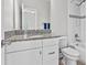 Bathroom featuring granite countertop, modern fixtures, and tiled shower at 1379 Kiawah St, Celebration, FL 34747