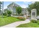 Townhome exterior with lush landscaping, beautiful flowers, and well-maintained signage at 1379 Kiawah St, Celebration, FL 34747