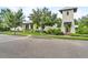 Street view of this home's elegant architecture, with lush landscaping enhancing its curb appeal at 1379 Kiawah St, Celebration, FL 34747
