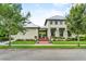 Elegant home entrance featuring a landscaped walkway, beautiful architecture, and lush surroundings at 1379 Kiawah St, Celebration, FL 34747