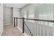 Hallway featuring neutral carpet, white railings, and natural light at 1379 Kiawah St, Celebration, FL 34747